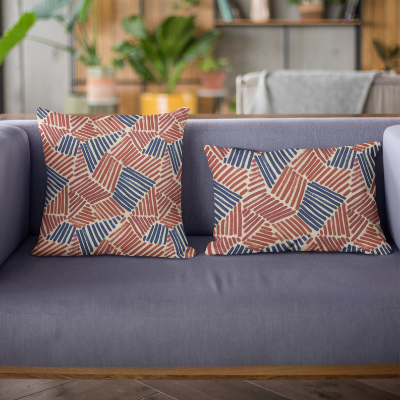 Pair of square throw pillows with red and blue abstract sketch pattern