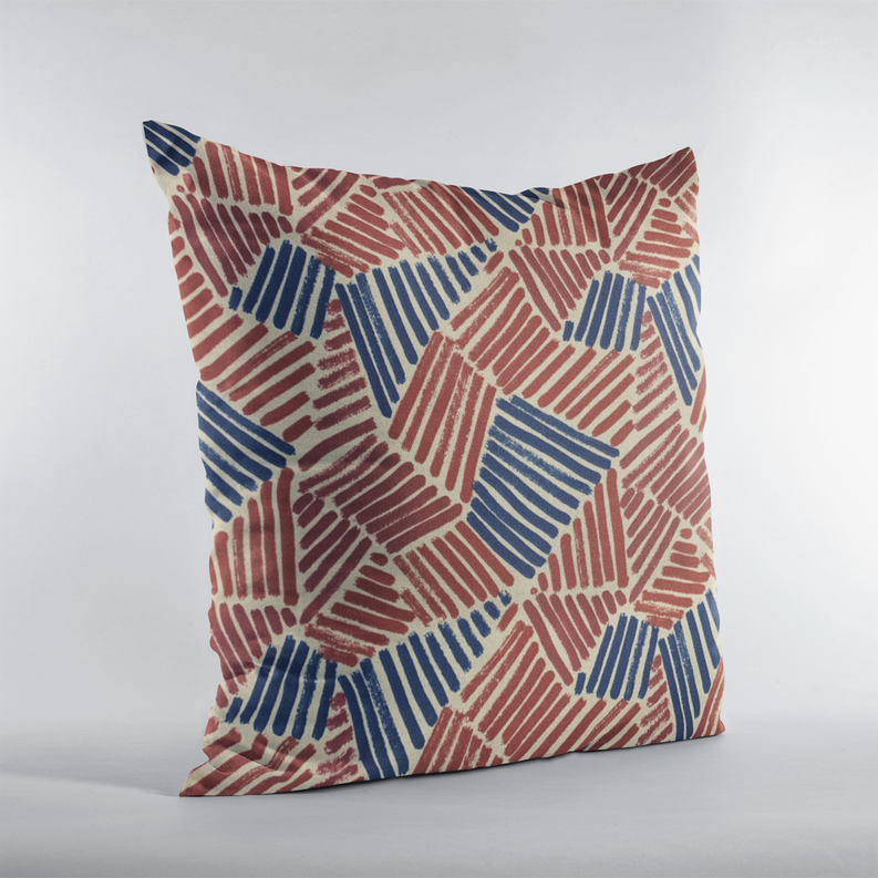 Luxury throw pillow featuring red and blue abstract sketch shapes on cream