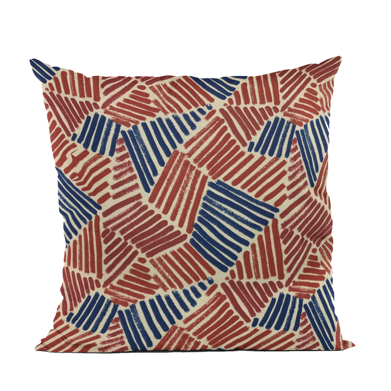 Luxury throw pillow with rust red and navy blue geometric abstract pattern, cream base