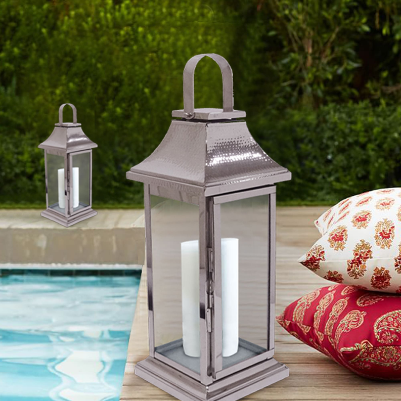 Silver metal candle lantern with glass panels and arched handle, open top