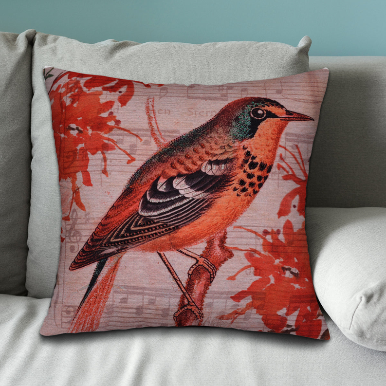 Bird-pattern pillow cover close-up on gray sofa with red orange bird design