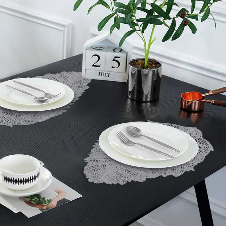 Silver leaf cut-out vinyl placemat with lace-like outline, oval leaf shape
