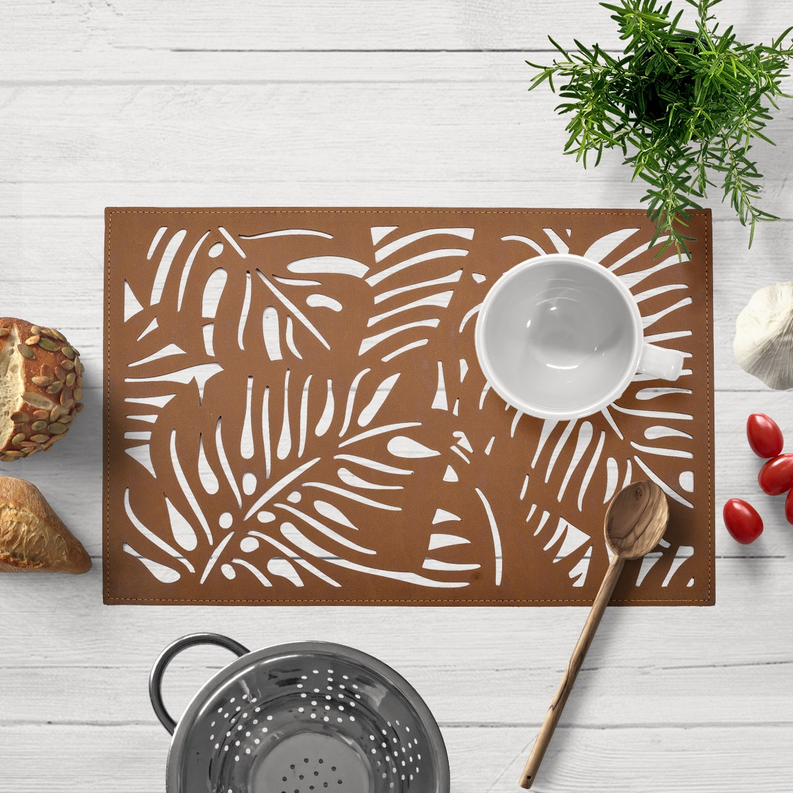 Brown leaf cut-out vinyl placemat, rectangular with white leaf silhouette cutouts