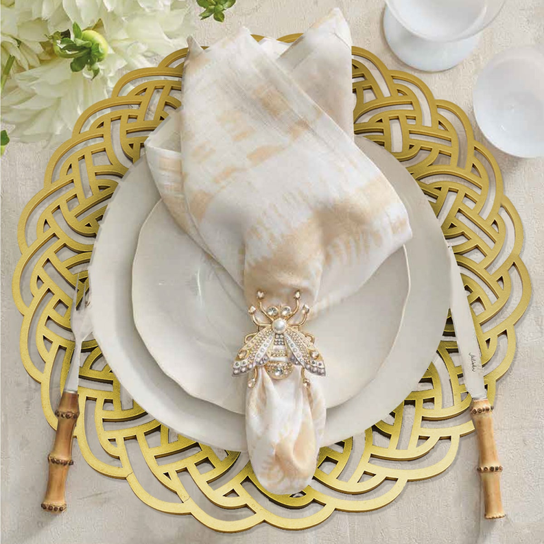 Round gold wooden lattice trivet with four short legs for plates and decor