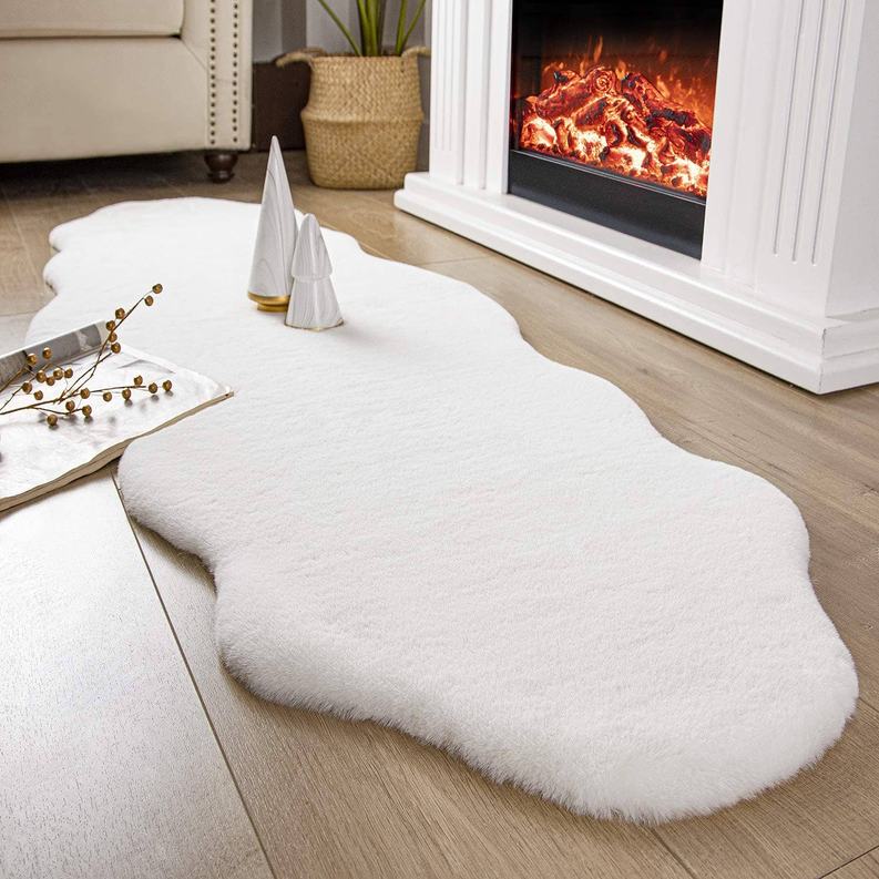 Faux rabbit fur shaggy plush area rug, white oval shaggy rug near fireplace and sofa