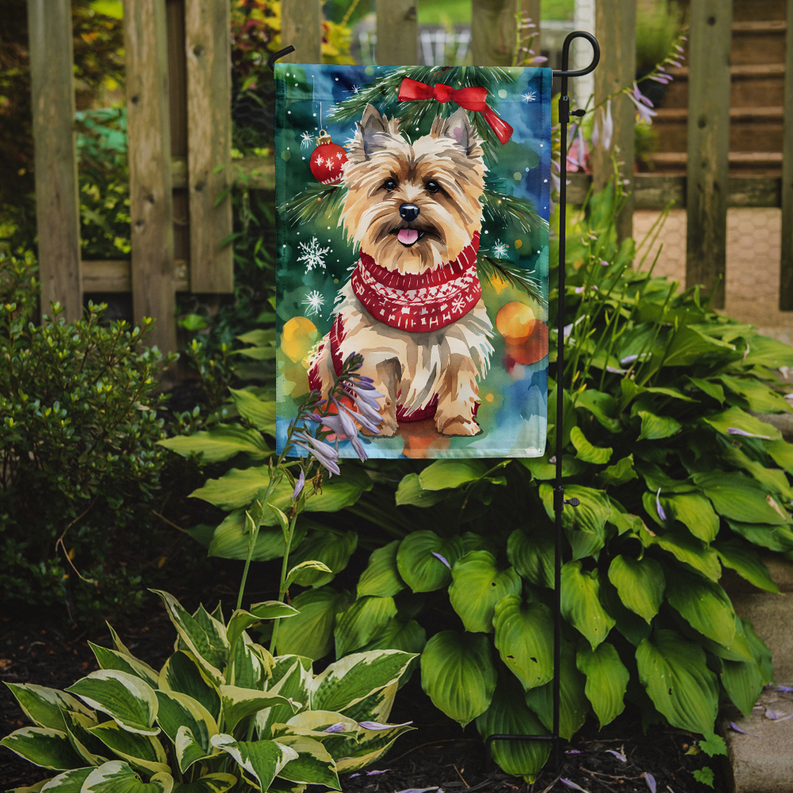 Christmas garden flag showing Cairn terrier in red patterned sweater with holiday decorations