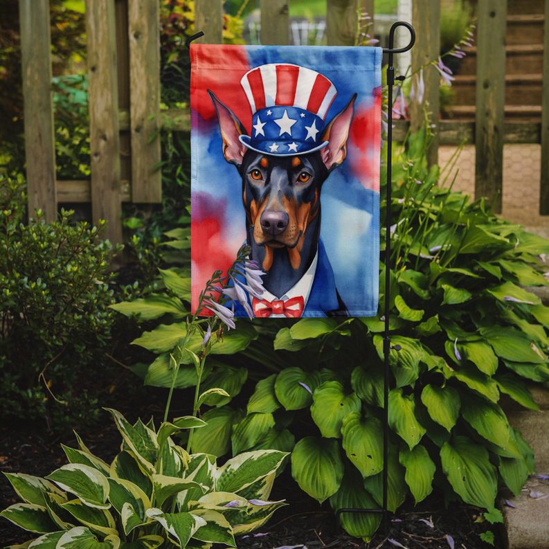Patriotic Doberman garden flag displayed on a metal yard stake with full dog portrait