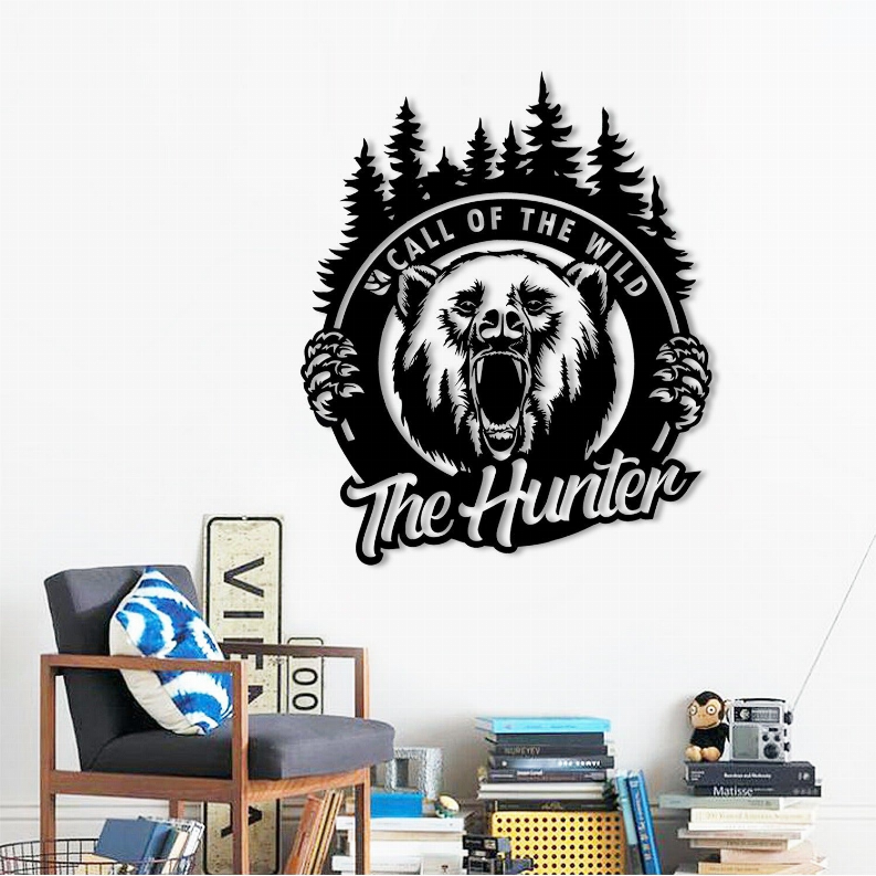Metal wall art of roaring bear emblem on wall above shelves and books