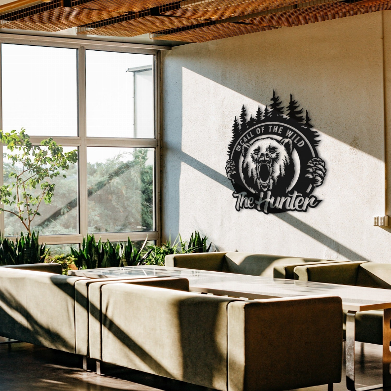 Metal wall art with black bear emblem and pine trees, 'The Hunter' logo