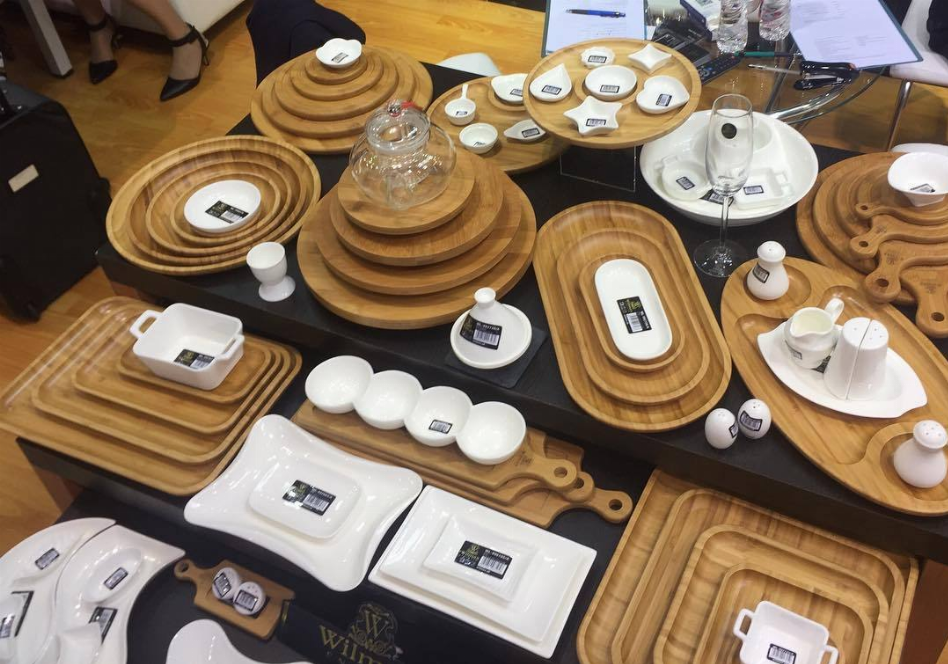 Set of wooden serving plates and platters with matching accessories on display
