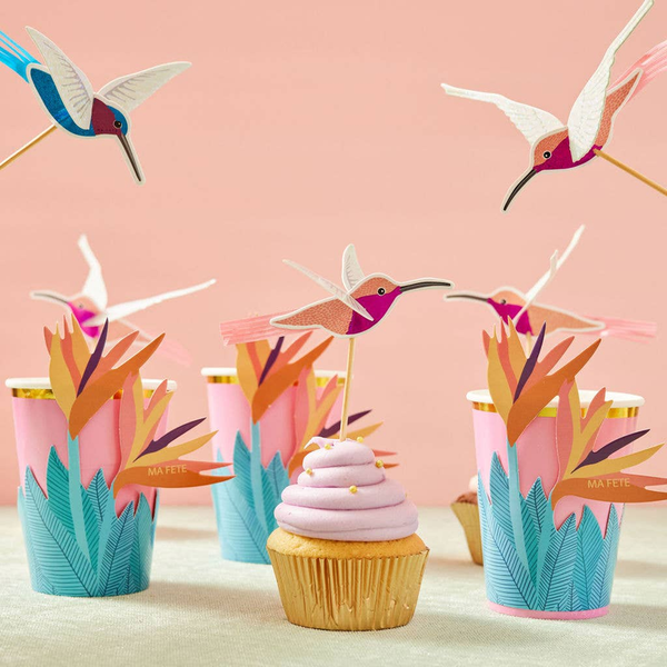 Tropical bird cupcake toppers with colorful flags on frosted mini cupcakes