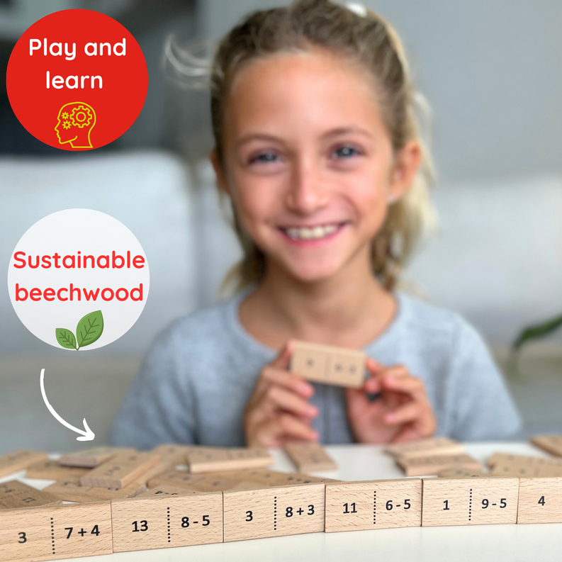 Child holding wooden number domino pieces above a partially built domino layout