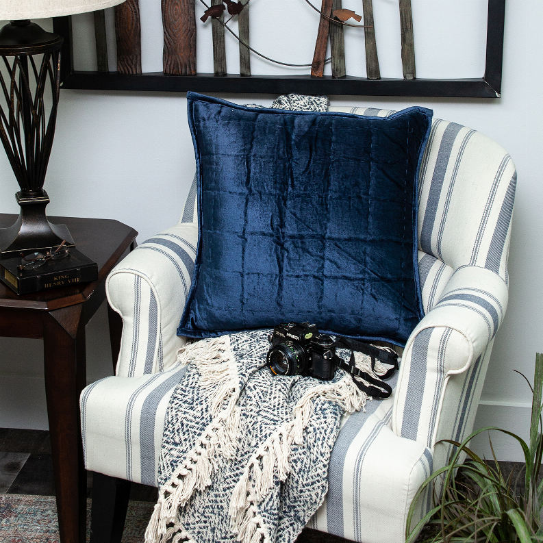Quilted navy blue throw pillow with stitched square channel pattern