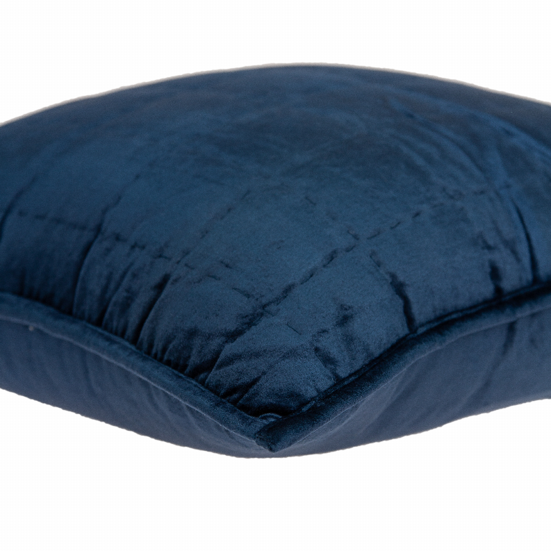 Navy blue throw pillow corner with tufted quilting and rounded edge