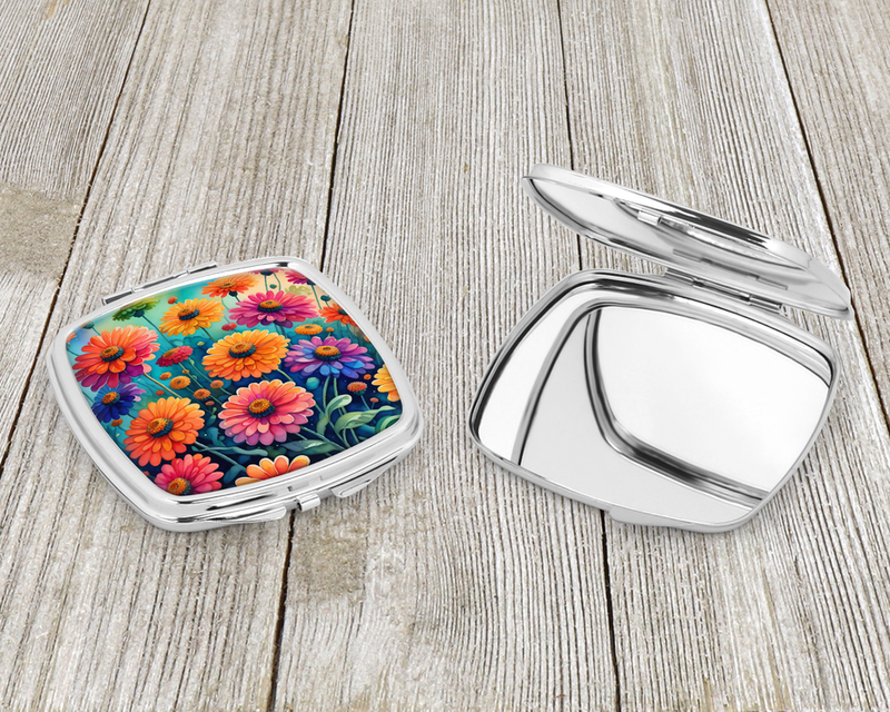 Compact mirror set with open lid and closed case; silver metal, colorful floral artwork.