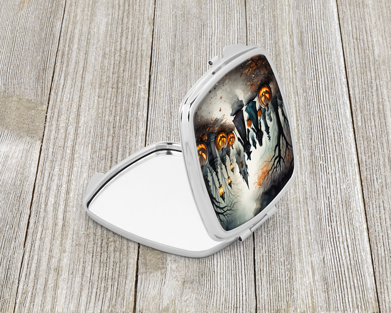Spooky Halloween compact mirror with silver frame and glowing jack-o'-lanterns on mirror