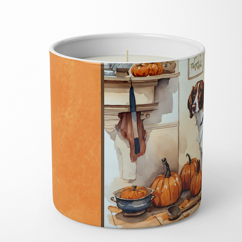 Soy candle in cylindrical glass jar with orange sides and printed fall pumpkins scene