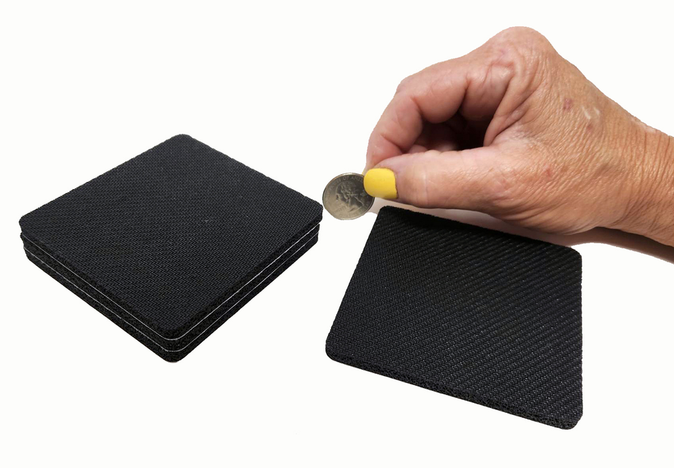 Dark foam square coasters with textured surface, set held by hand