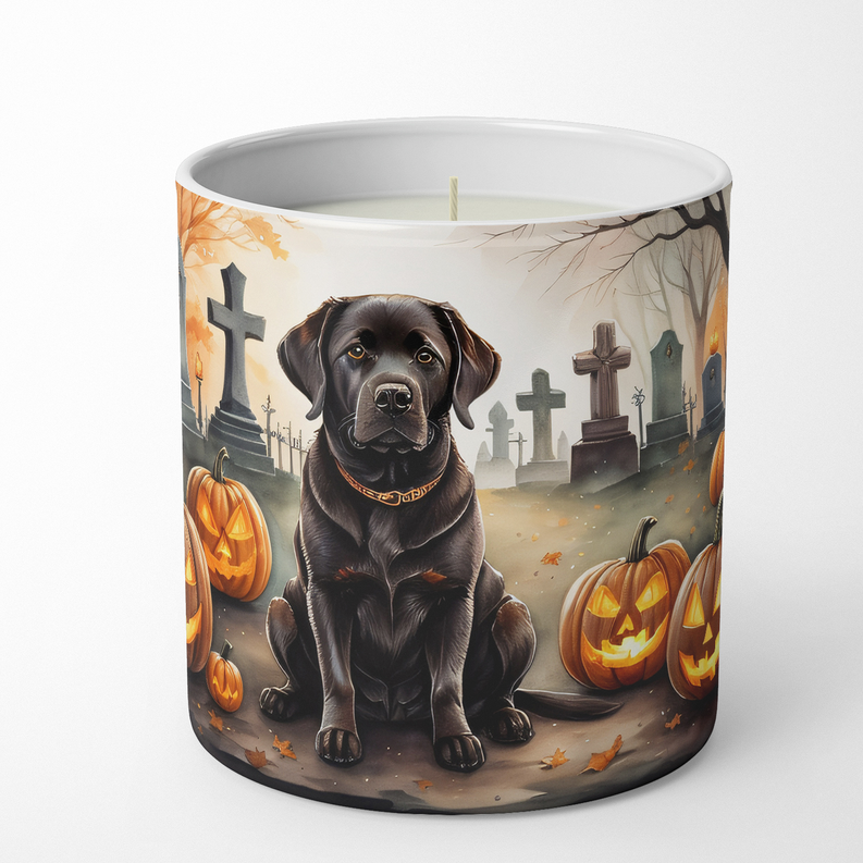 Black lab dog candle with Halloween theme, featuring orange pumpkins and graveyard artwork on a white container.