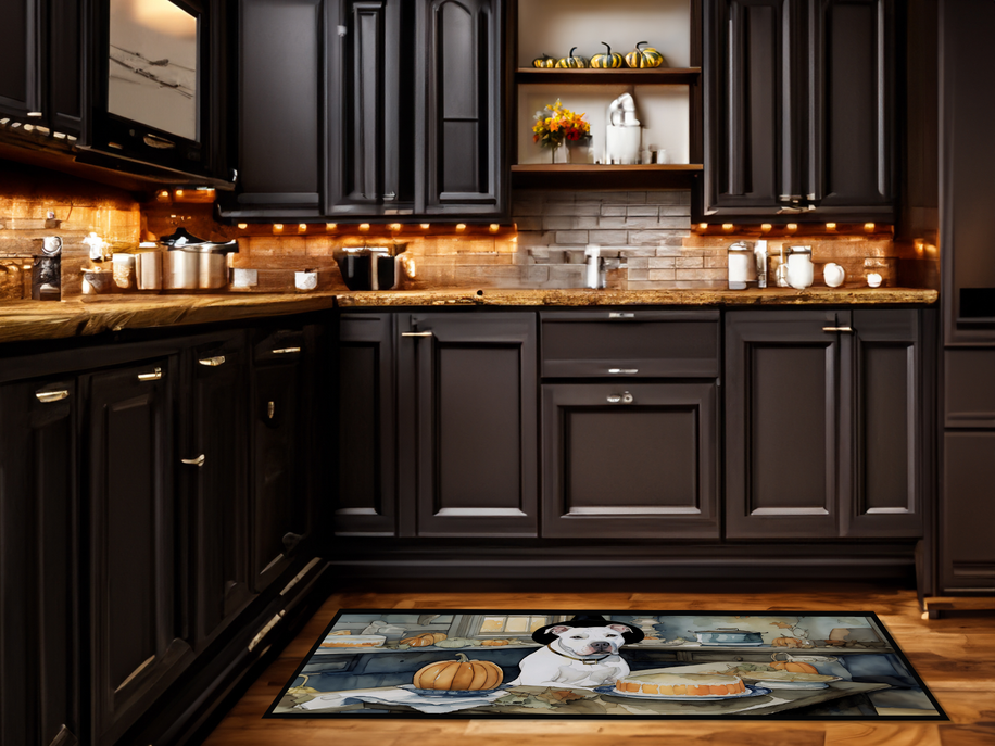 Decorative kitchen rug mat with white dog and orange pumpkins on dark kitchen floor