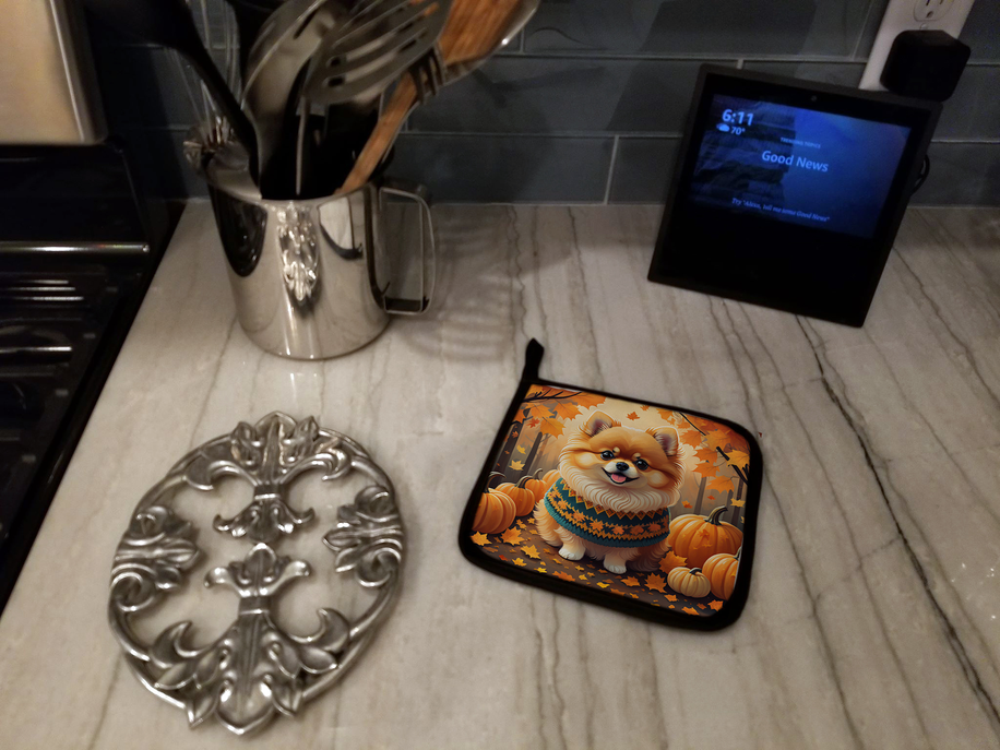 Foam coaster on marble with a dog print, pumpkins, and autumn leaf pattern