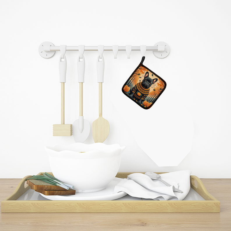 Dog-themed fall pot holder hanging by a hook on a kitchen wall