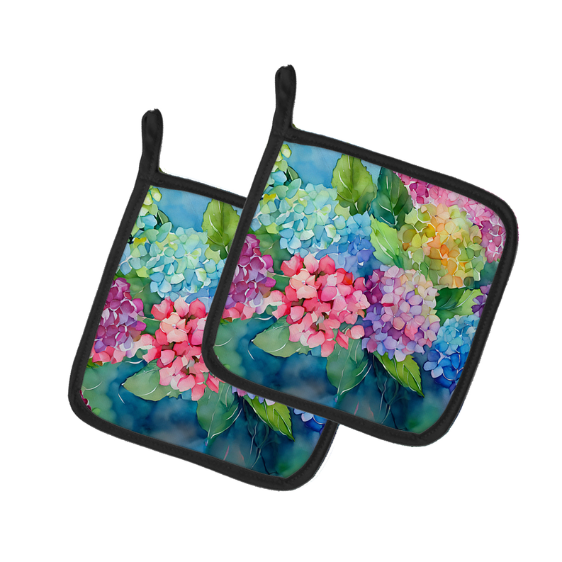 Pair of watercolor pot holders with black trim and hydrangea-style multicolor flowers.