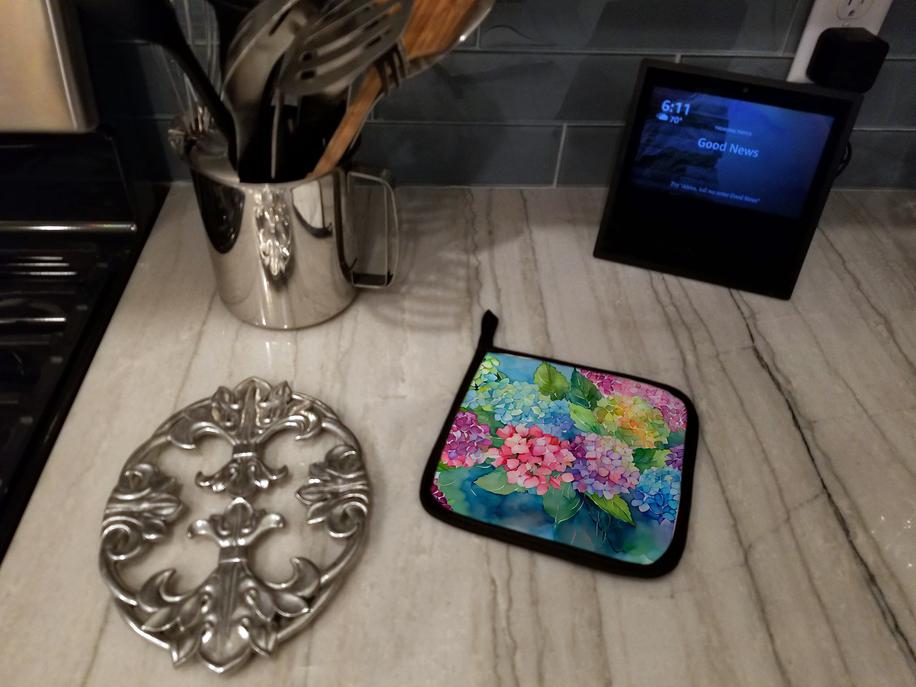 Watercolor floral pot holder with blue, pink, and green print, black trim