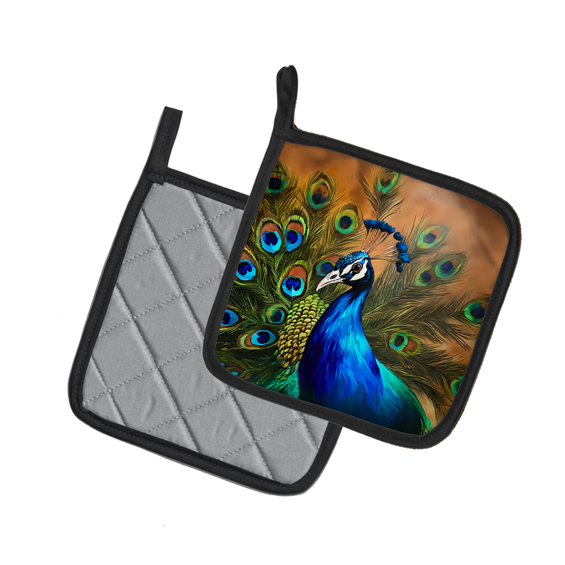 Vibrant peacock design pot holder, featuring colorful feathers on a quilted gray background, with black trim.