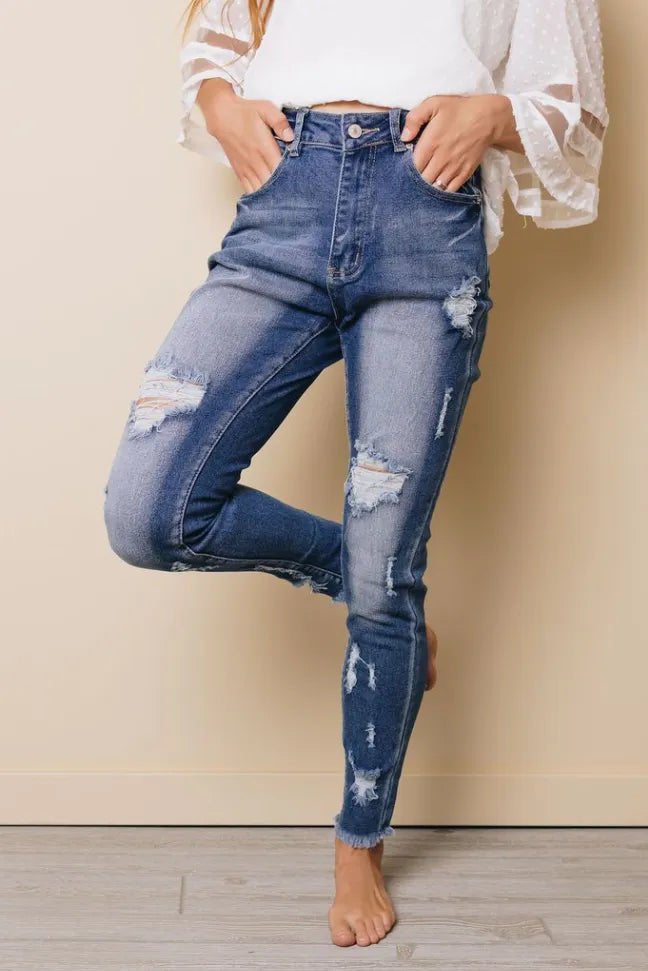 High-rise distressed skinny jeans, ripped knees and thighs, five-pocket denim