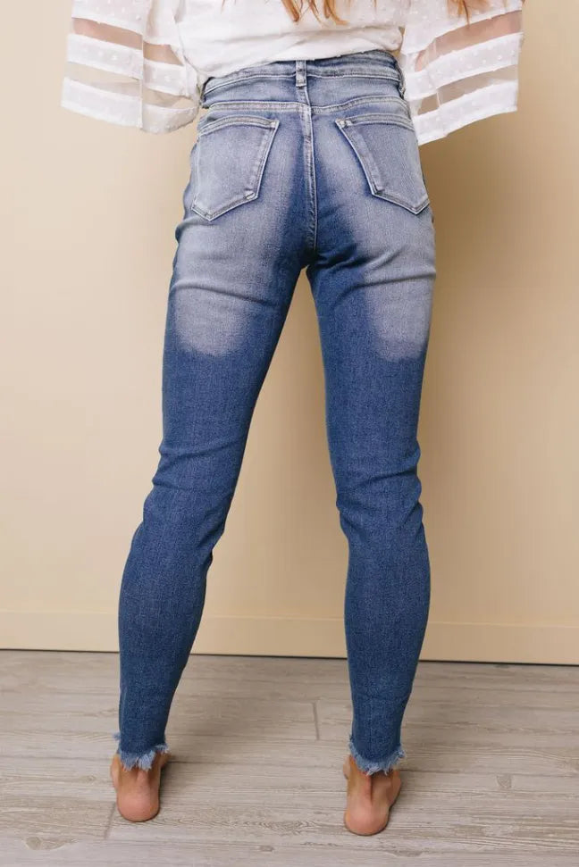 High-rise distressed skinny jeans, back patch pockets and tapered denim legs