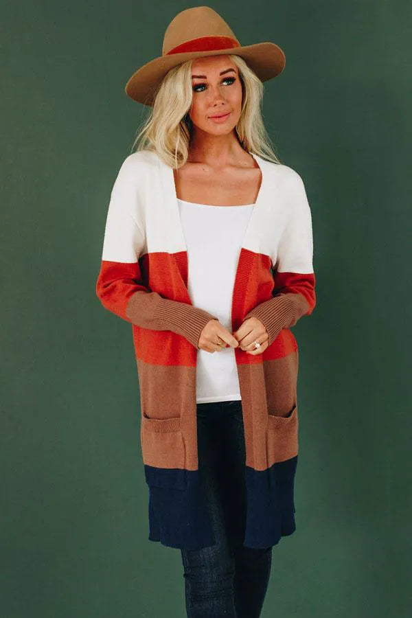 Women’s color-block cardigan with white top, red mid, tan side panels, and navy hem