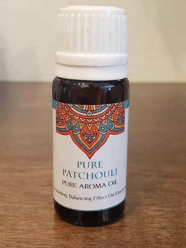 Patchouli pure aroma oil bottle with amber liquid, white ribbed cap, mandala label