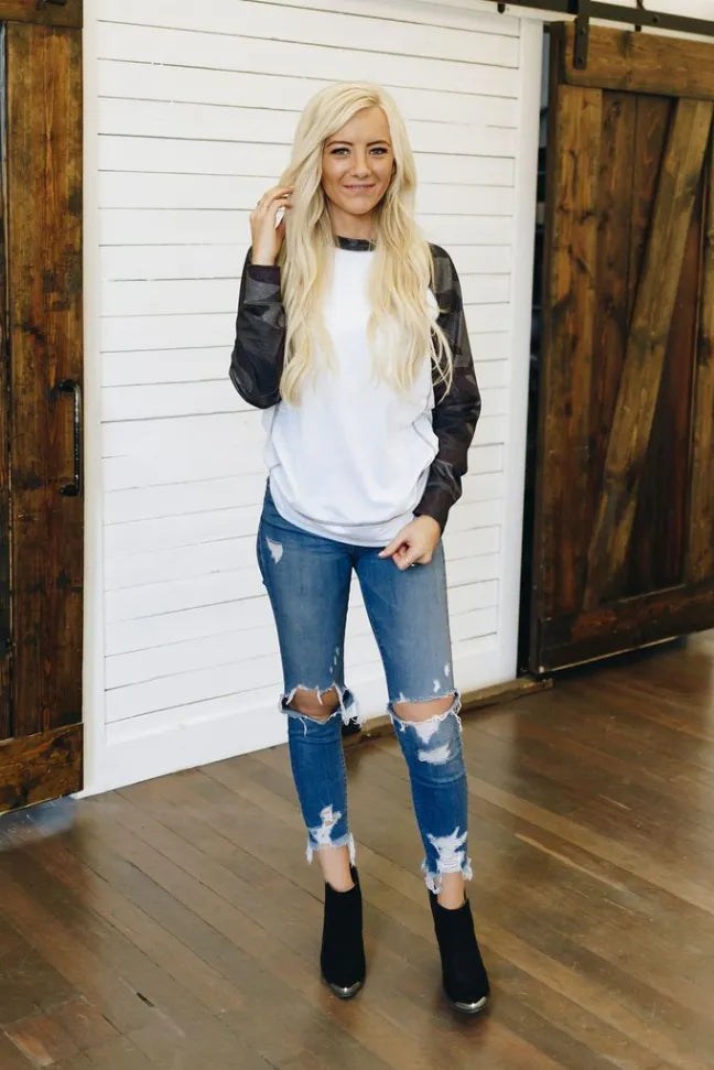 White crewneck pullover with dark camo raglan sleeves
