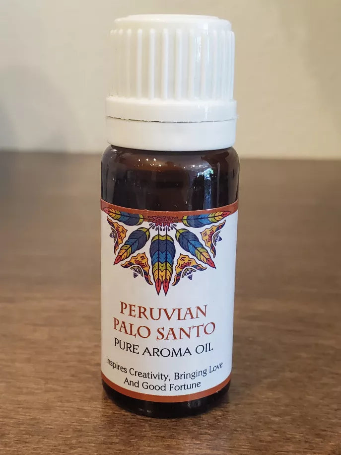 Aromatherapy oil bottle with white cap; Peruvian Palo Santo label and blue-gold emblem
