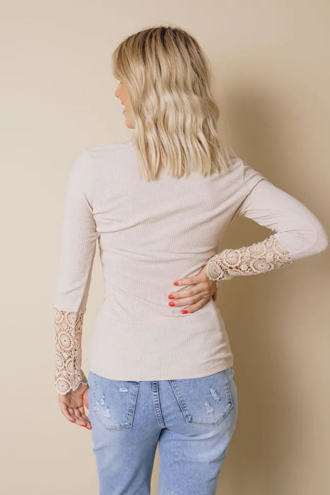 Long sleeve knit top with lace cuffs and V-neck seam detail, light beige