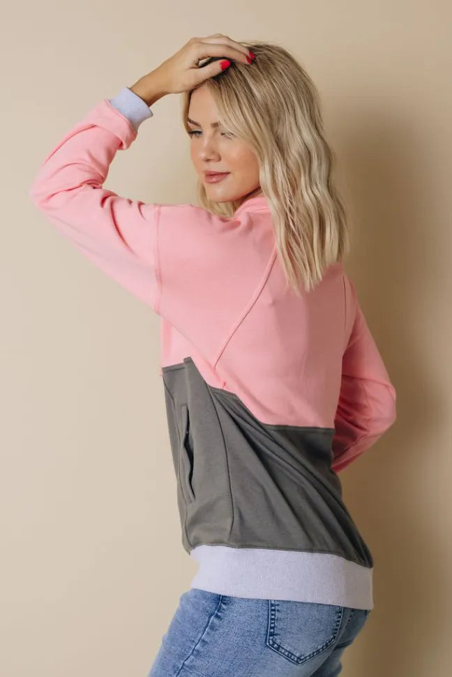 Side view pink zip-up colorblock hoodie with charcoal gray panel and ribbed cuffs