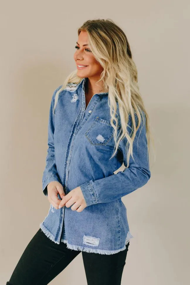 Light blue distressed denim button-up top with frayed cuffs, chest pocket, and slit hem