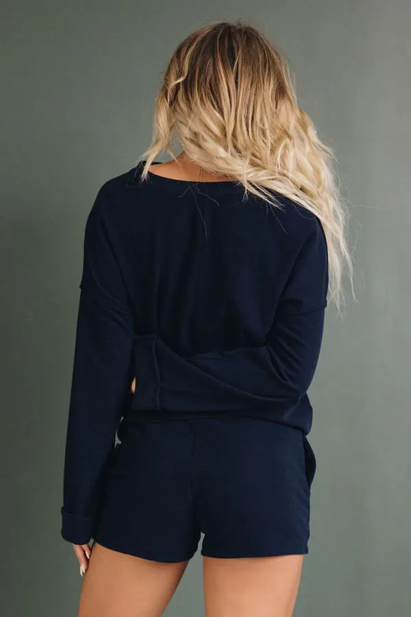 Chanel loungewear set in navy: long-sleeve back view with tied waist shorts