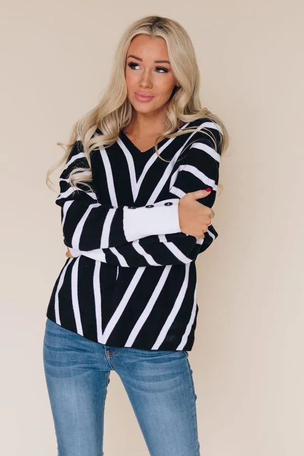 Black and white striped V-neck knit sweater, long sleeves, front view