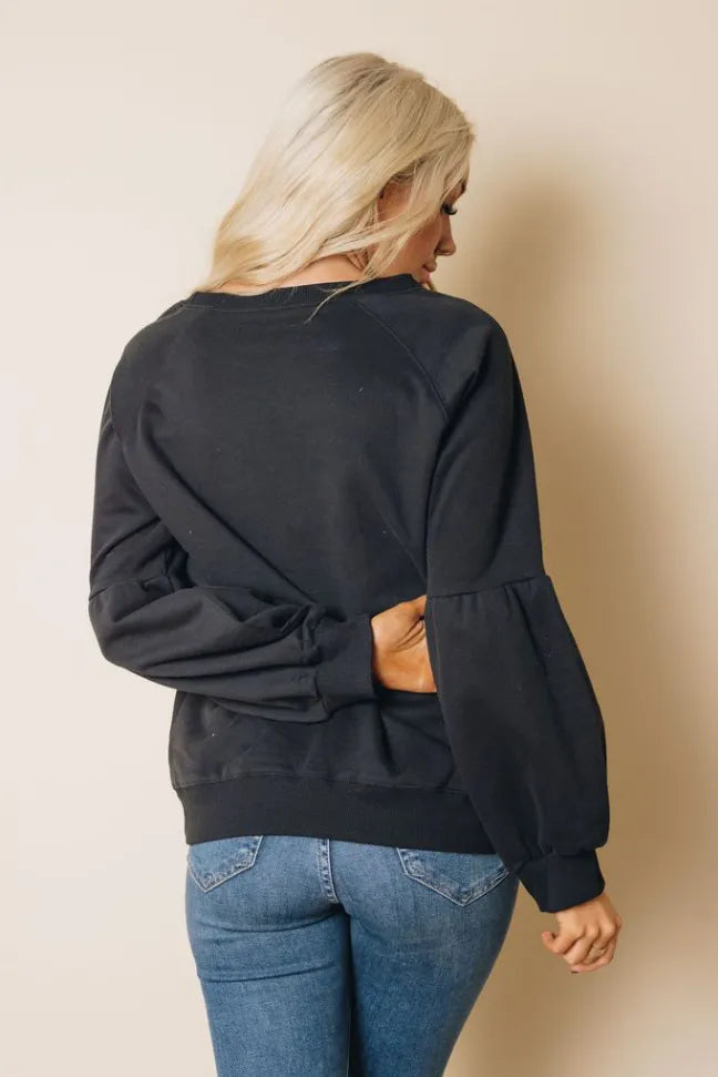Black balloon-sleeve sweatshirt back view with ribbed cuffs