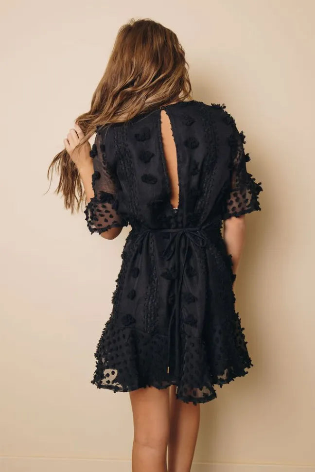 Black Swiss dot mini dress open back with ruffled sleeves and waist tie