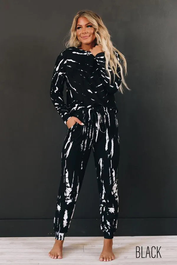 Black loungewear set with hooded top and drawstring jogger pants, white splatter print