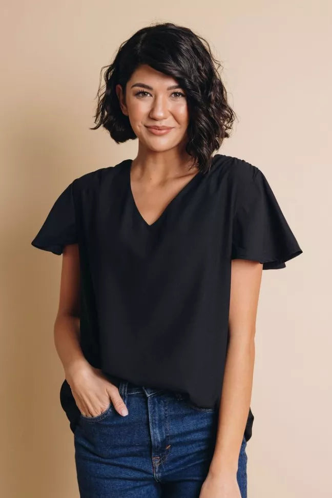 Women’s dark short-sleeve V-neck top with ruffled sleeves, front view