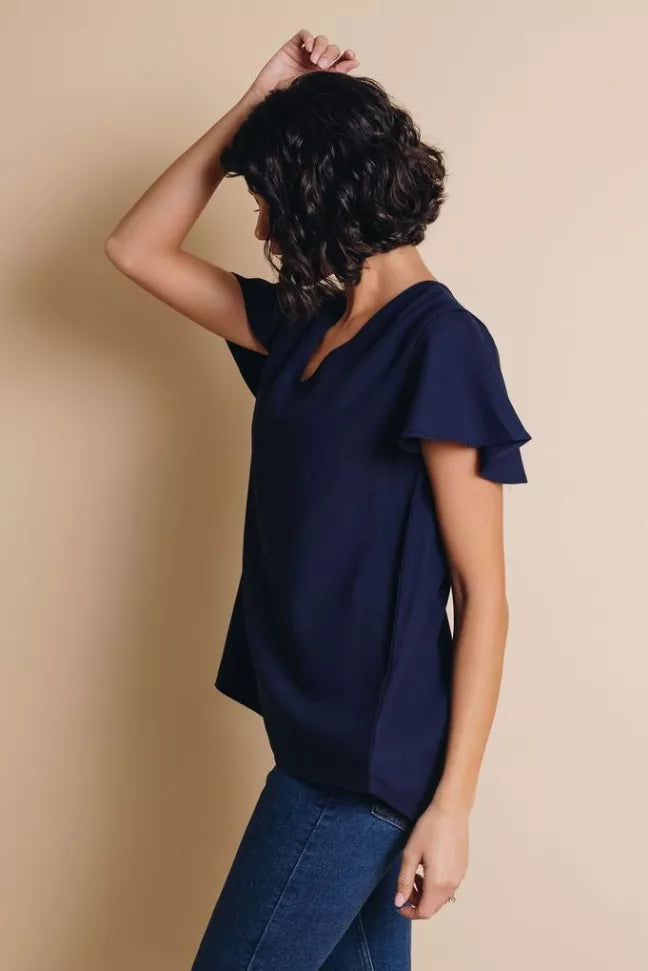 Navy V-neck short-sleeve top, side/back view with flutter sleeves