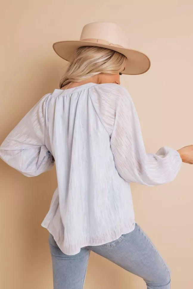 White long-sleeve top, back view with gathered shoulders and flowing sleeves
