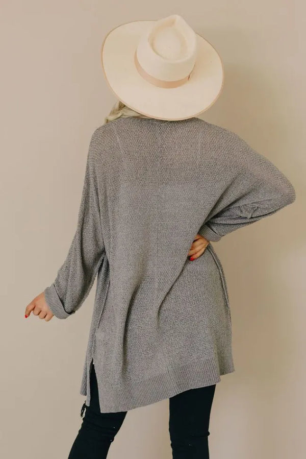 Gray knit cardigan back view with long sleeves and draped hem