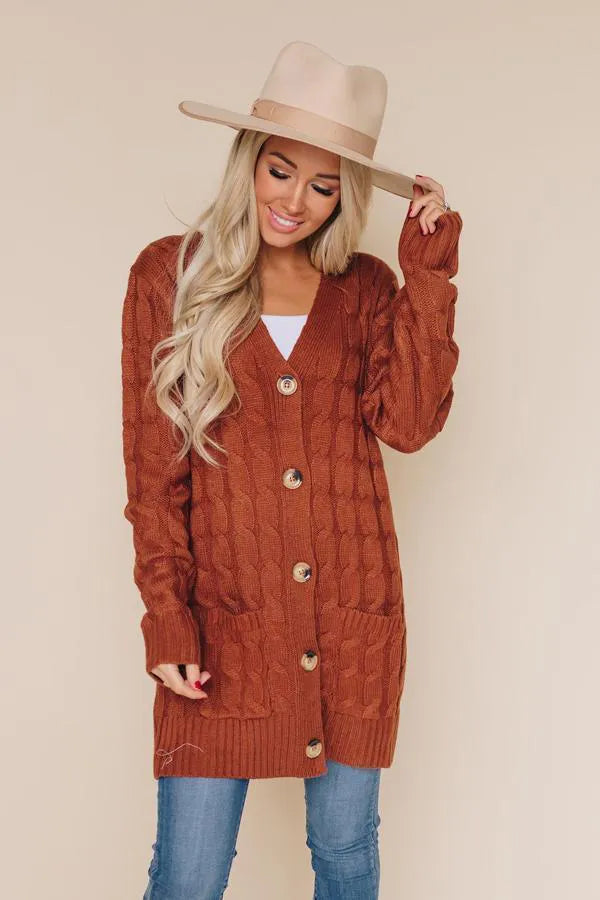 Rust cable-knit button-front cardigan with pockets, long sleeves, V-neck