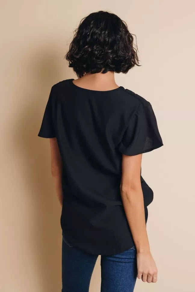 Black short-sleeve top, back view with round neckline and relaxed length