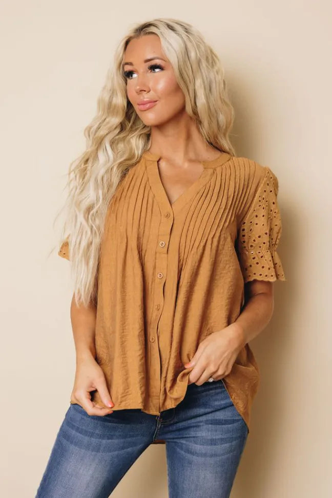 Brown pleated blouse with V-neck button front and short eyelet sleeve cuffs
